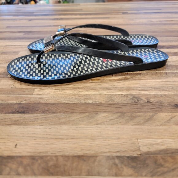 Coach Landon jelly flip flops in black with a gold bow and white pattern. - Picture 6 of 12
